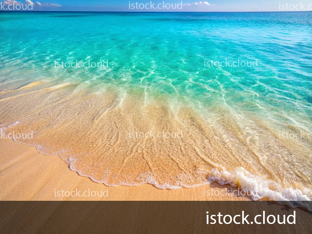 A tranquil beach scene featuring clear turquoise waters gently lapping at a sandy shore under a bright blue sky.