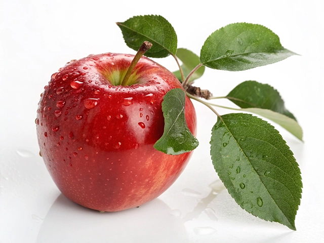A close-up image of a red apple with water droplets on its surface, featuring green leaves attached to the stem, against a white background.