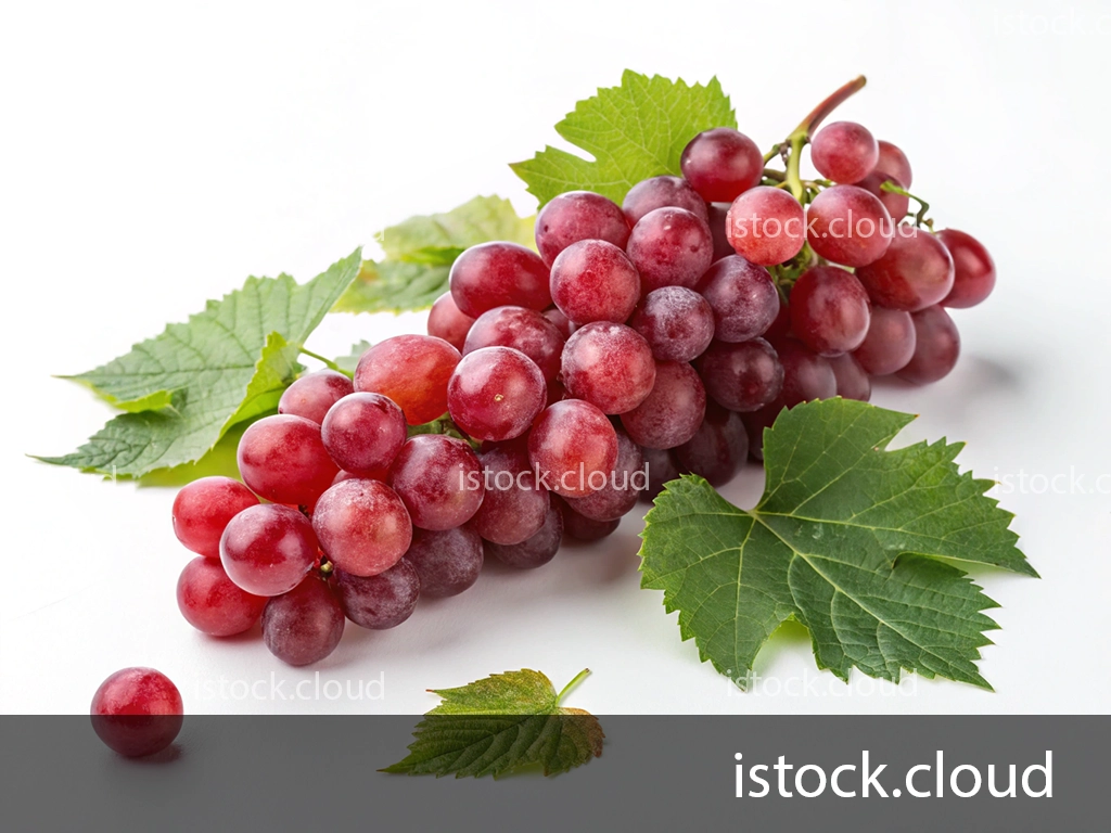 A bunch of ripe, red grapes with a few green leaves on a white background. One grape is separated from the bunch, lying next to the leaves.