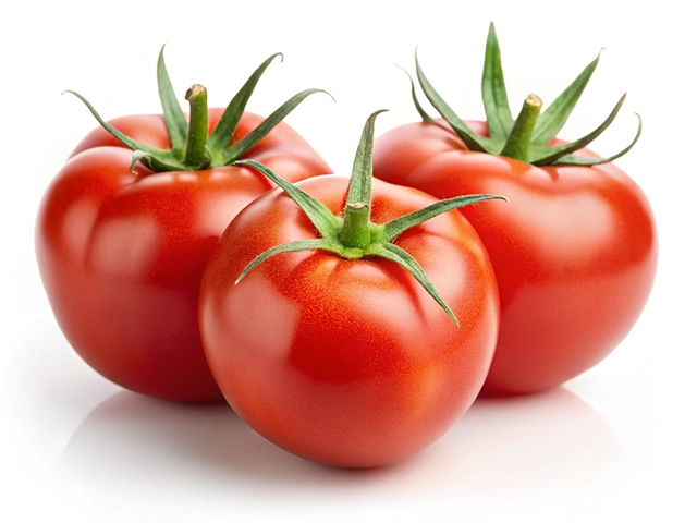 Three ripe red tomatoes are arranged closely together, showcasing their smooth skin and green stems against a white background.
