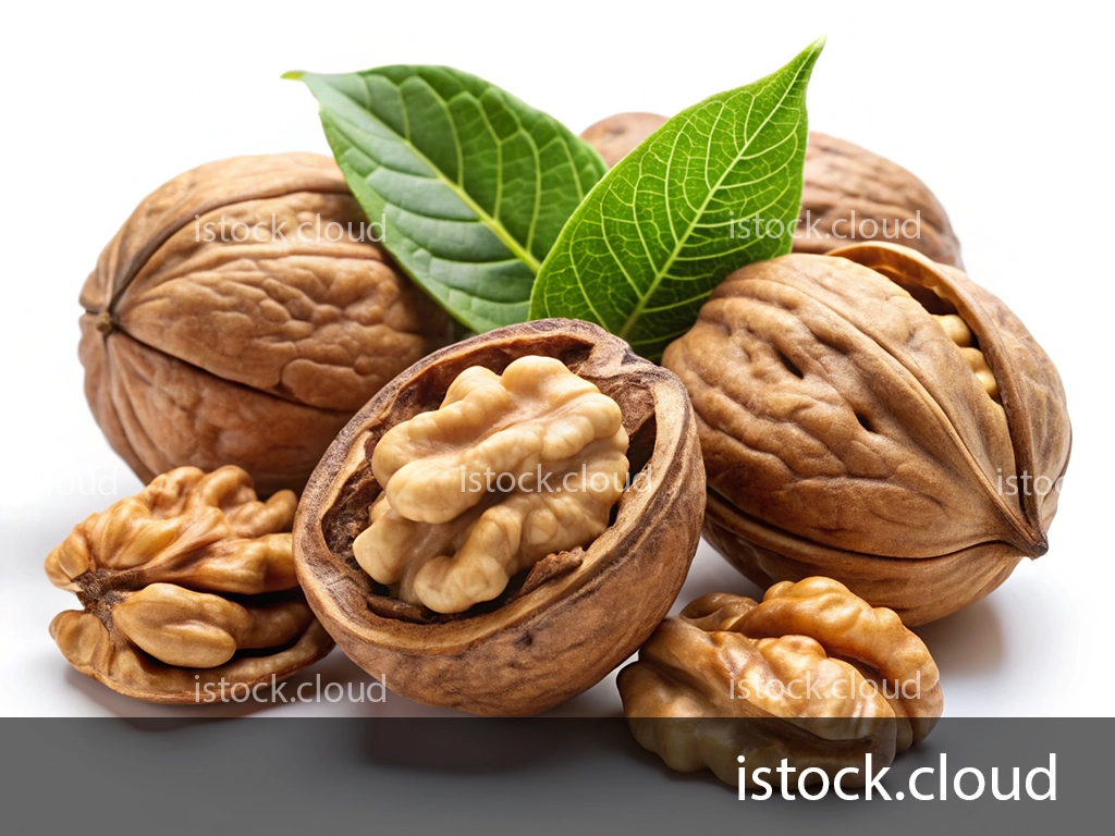 A collection of walnuts, some whole and some broken open to reveal the edible nut inside, accompanied by green leaves on a white background.